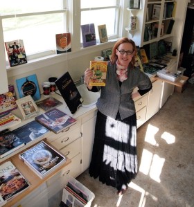 Danya Simkus holds a treasured copy of a Dinah Shore cookbook. Her store