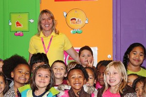 Naval Academy PE teacher Debbie Lindgren poses with student during lunch time in the school gymnasium. Students at the elementary school call her “Mrs. L.”