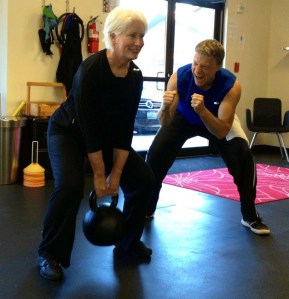 Celebrity fitness trainer James Bowman works with clients at his gym