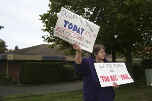 Evelyn Hetrick of Port Orchard takes part in a demonstration Friday afternoon at the corner of Mile Hill Drive and Olney Avenue