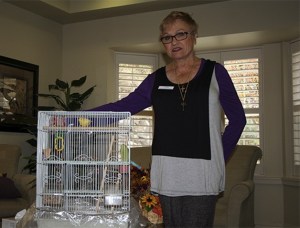 Mona Santos stands with her bird