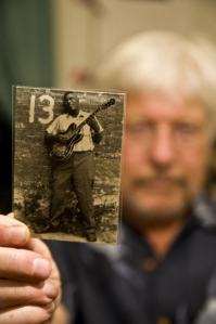 Kitsap’s Mark Hoffman shows a photo of legendary blues singer Howlin’ Wolf. Hoffman co-wrote what is considered the definitive biography of the Wolf and is gearing-up for the late singer’s 100th birthday next month.