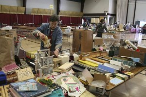 Cathy Doney with the East Bremerton Rotary Club organizes items Tuesday for Saturday’s community-wide rummage sale to benefit Rotary Clubs throughout Kitsap County.