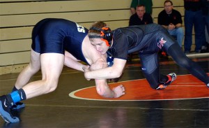 CK’s Calvin Fischer  wrestles Scott Bardell of Arlington.