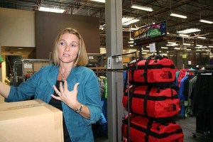 REI store manager Greta Eaton Caulfield speaks about setting up the new store in Silverdale. More than 100 people are helping assemble shelves and placing product. The store will open Oct. 4.