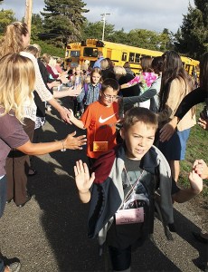 School kids walk through the Tunnel of Hope on the first day of school Sept. 9 at South Colby Elementary in Port Orchard.