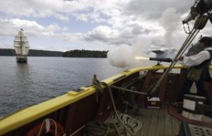 Lady Washington gunner Roscoe Washcher fires a mock cannon at the Hawaiian Chieftain during Wednesday's battle sail in front of the Port of Brownsville.