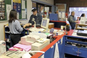 Liezl Rebulado rings up Robert Balogh's mail costs as a line of customers snakes outside the door at the Poulsbo post office