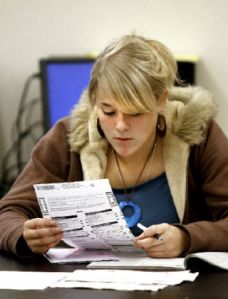 Kingston High School senior Sierra Moon studies her ballot during her Contemporary World Issues class. Moon