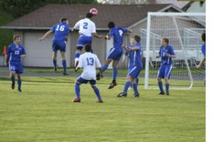 Bremerton midfielder Alex Membrere (2) goes up for a header during the Knights playoff-clinching 4-1 victory against Olympic at Memorial Stadium on Tuesday.