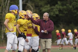 Kingston Buccaneers head coach Todd Harder runs drills with the varsity squad during practice Sept. 2 at Buc Field.