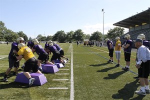 North Kitsap coach Jerry Perrish runs drills with varsity players Sept. 3 at North Kitsap Stadium.