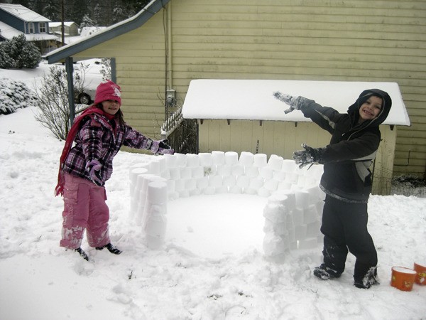 Kiarra and Isaac Tate made an igloo Wednesday in Gamblewood. 'Five inches of snow