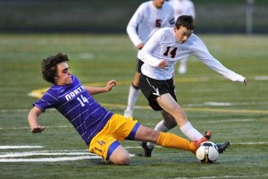 North Kitsap's Fisher Young slides in for a steal against Central Kitsap's Brian Bonafilia Tuesday at the North Kitsap Stadium.