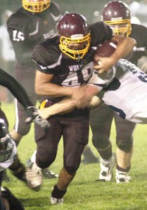South Kitsap running back Michael Neiner plows ahead on a sloppy field on Friday in the Wolves’ loss to Olympia.