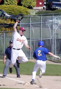 Kingston High first baseman Danny Orr leaps for a ball as Fife’s Tyler Stevens tags safely May 14 at Legion Field in Bremerton.