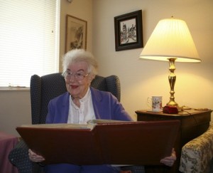 Bremerton resident Kathryn Hess looks over newspaper clippings detailing her longtime involvement with the Silverdale library. Hess’s 100th birthday will be celebrated at a Silverdale community party Sunday.