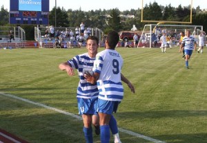 Kitsap Pumas forward Robbie Christner celebrates with teammate Cameron Hepple after scoring a goal in the 42nd minute to give the Pumas a 2-1 lead against Real Colorado Tuesday in the U.S. Open Cup. The Pumas advance to play the Seattle Sounders in the third round of the tournament next week in Tukwila.