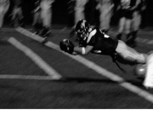 Running back senior Brad DeShano dives into the end zone