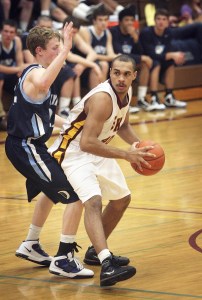 South Kitsap senior Quintin Harris is harassed by an Olympia defender in the Wolves’ 77-27 loss on Wednesday night.