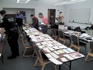 Port Townsend police sort mail that was recovered from identity and theft suspect Adam Justin Lysiak.