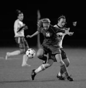 Bremerton’s Rachael Pratt (14) fights for position against Olympic’s Nina Mass Oct. 21.