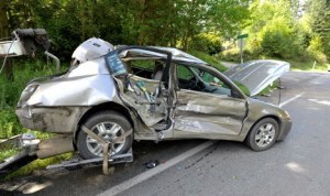 A tow truck prepares to pull a sedan away from the scene of a three-car collision on State Route 104 at Ritter Lane on Tuesday morning.