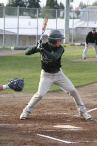 (Left) KSS’ Brandon Neet waits for a pitch during the Eagles’ 8-2 win against Eatonville at Legion Field in Bremerton on Tuesday. (Above) Eric Eley