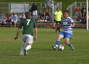 Pumas defender Mark Lee dribbles against Portland Timbers U23 midfielder Michael Nielsen July 18 at Bremerton Memorial Stadium.