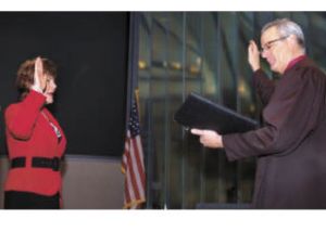 Patty Lent is sworn in by Bremerton Municipal Court Judge James Docter before a packed house at the Norm Dicks Government Center Nov. 25.