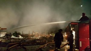 Firefighters spray water on a Port Orchard home that exploded around 4 a.m. Feb. 23.