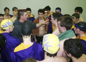 Assistant coach Jeff Reeves gives the North Kitsap High boys swim team a pep talk between events Jan. 26 at the North Kitsap Community Pool