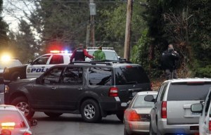 A police officer leads an unidentified subject to a squad car