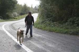 Mike Dominguez strolls with his dog