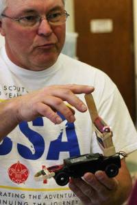 Brad Griffith shows a pinewood derby car with recording capabilities Sunday at the Kitsap MiniMaker Faire.