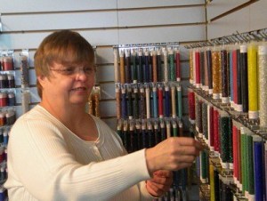 Cindy Carroll updates her inventory of beads.