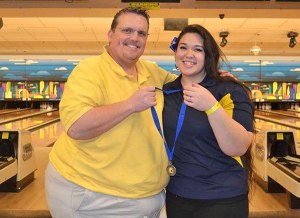 Coach Dean Wagner and Megan Wittenberg pose with Wittenberg’s first place medal.