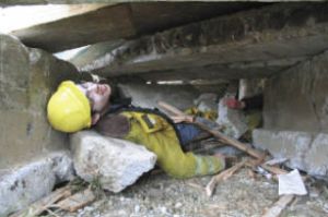 Josh Barker played a victim trapped inside the “collapsed gym” at Klahowya Secondary School Monday. Local agencies practiced their response to a school attack with a Homeland Security-funded drill at the Silverdale school.