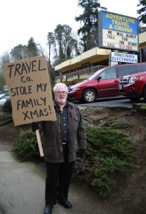 Dale Ashton continues his daily sidewalk protest in front of Adventure Travel & Cruise