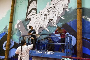 Native American artist Toma Villa explains the movement of the bears in the canoe to Chief Kitsap Academy students