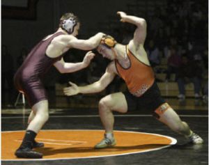 Cougar Howie McDonald battles for position against South Kitsap’s J.C. Parker. McDonald won the match at 189 pounds