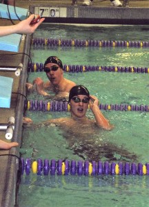 North Kitsap’s Thor Breitbarth checks the scoreboard for results as Kingston’s Ethan Fox looks over his shoulder