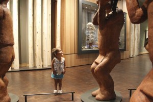Lilia Cruz of Suquamish dances around the canoe sculpture in the new Suquamish Museum.