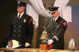 A ceremonial fire bell is rung three times in honor of retired Poulsbo Deputy Fire Chief Tom Huddleston