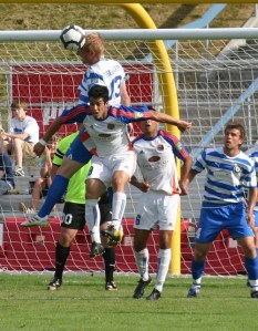 Kitsap Pumas midfielder John Fishbaugher (13) goes up for a header against two Ventura County Fusion Saturday at Bremerton Memorial Stadium. The Pumas won in penalty kicks.