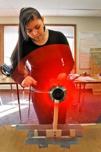Junior Calina Lawrence tends the windmill she built with partner Charissa Sigo during the MESA engineering design competition May 7.