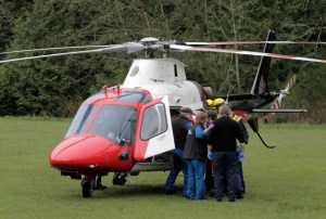 A 34-year-old Kingston woman was airlifted to Harborview Medical Center in Seattle for injuries sustained after she exited the passenger side of a moving truck. She was then run over by the truck.