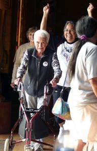Marilyn Wandrey cheers as Betty Peck completes her 17th lap at the end of the Elders Dash