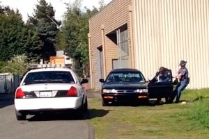 A deputy with the Kitsap County Sheriff's Office and a State Trooper take Hopkins into custody April 22.