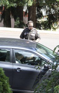 A Kitsap County Sheriff's deputy monitors vehicles entering Steele Creek Mobile Home Park